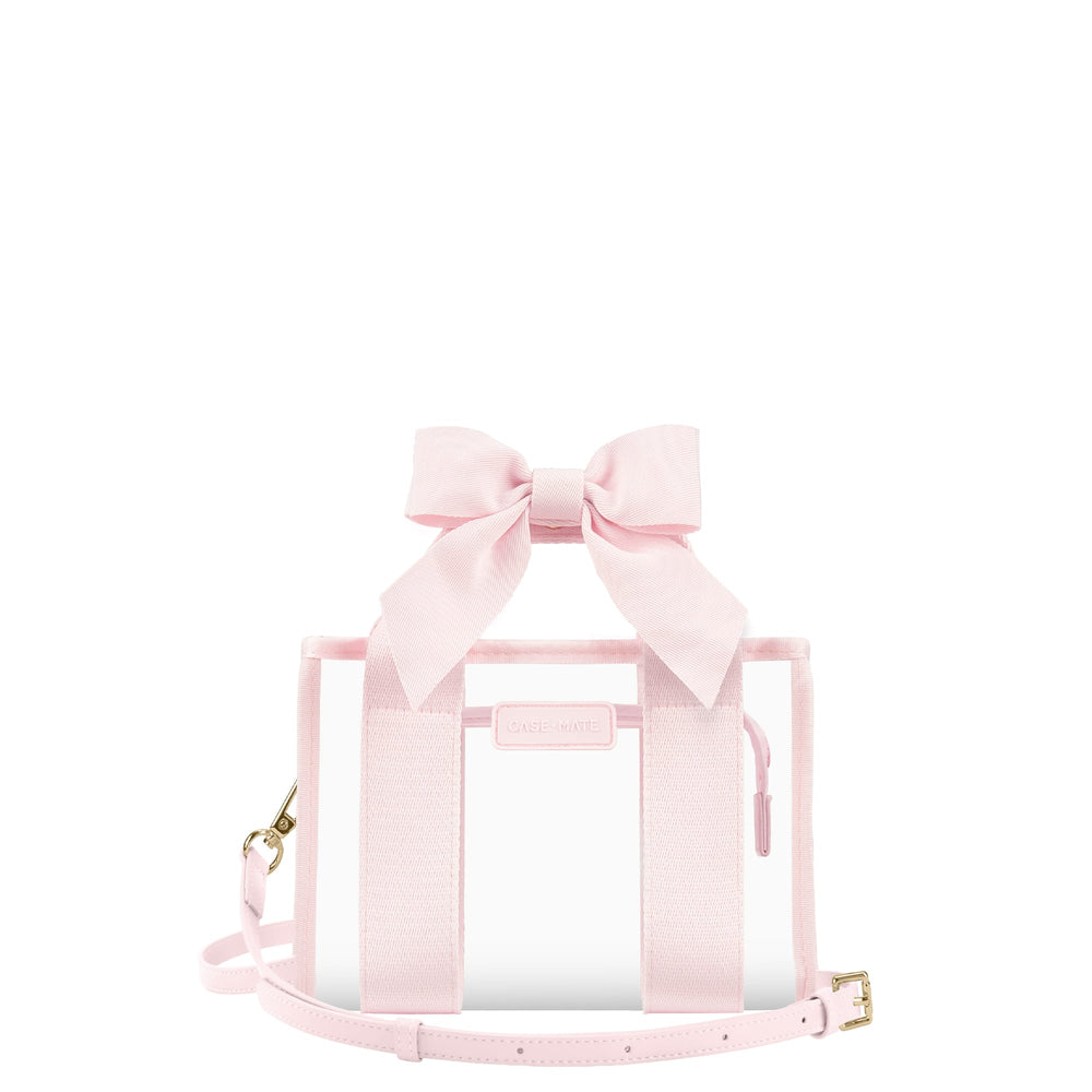 A light pink transparent tote bag with a large matching fabric bow on top, pink webbing handles, a thin shoulder strap, and small gold-tone hardware, shown on a plain white background.

#color_ballet pink bow