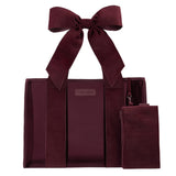 Red velvet straps on a burgundy Jelly Tote Bag on a while background 
#color_holiday edition red velvet bow