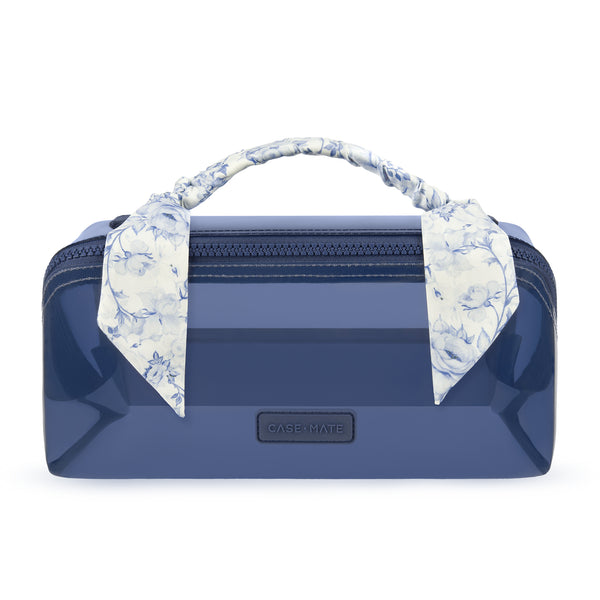 A glossy navy blue cosmetic case with a top zipper, featuring a matching floral necktie handle and a small black CASEMATE logo plaque on the front.
#color_something navy twilly