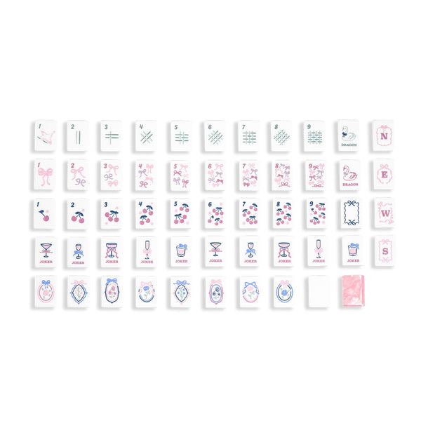 A set of small rectangular Mahjong Jelly tiles arranged in rows on a white background, each featuring different printed symbols, letters, and illustrations in pink, blue, and black. 
#color_ballet pink pearl edition