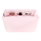 Pink fabric organizer with compartments containing various items on a white background
#color_ballet pink