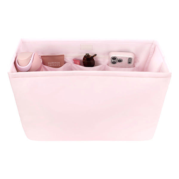 Pink fabric organizer with compartments containing various items on a white background
#color_ballet pink