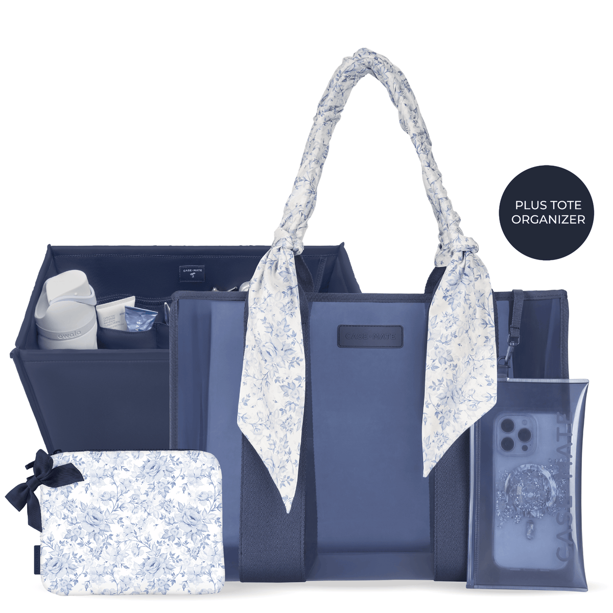 A navy blue tote organizer set with matching light blue and white floral accessories, including a large tote bag with floral handles, a zippered organizer pouch, a small pouch with a black ribbon, and a clear phone case, shown on a white background with a black circular badge that reads 'PLUS TOTE ORGANIZER'.