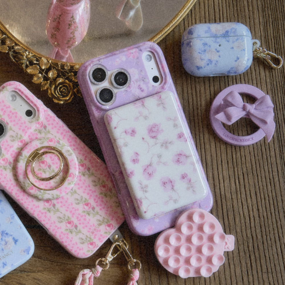 Collection of pink and floral phone cases on a wooden surface
#color_blooming heirloom