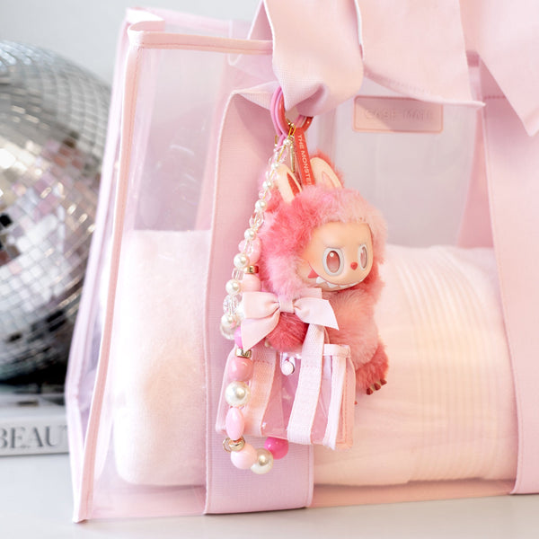 Pink plush keychain with decorative elements on a pink background
#color_ballet pink bow