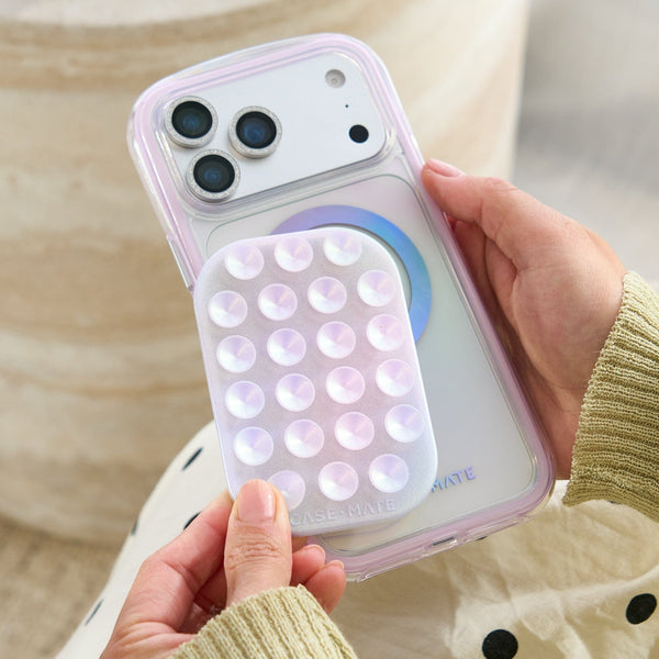 Phone case with bubble design held by a person #color_iridescent