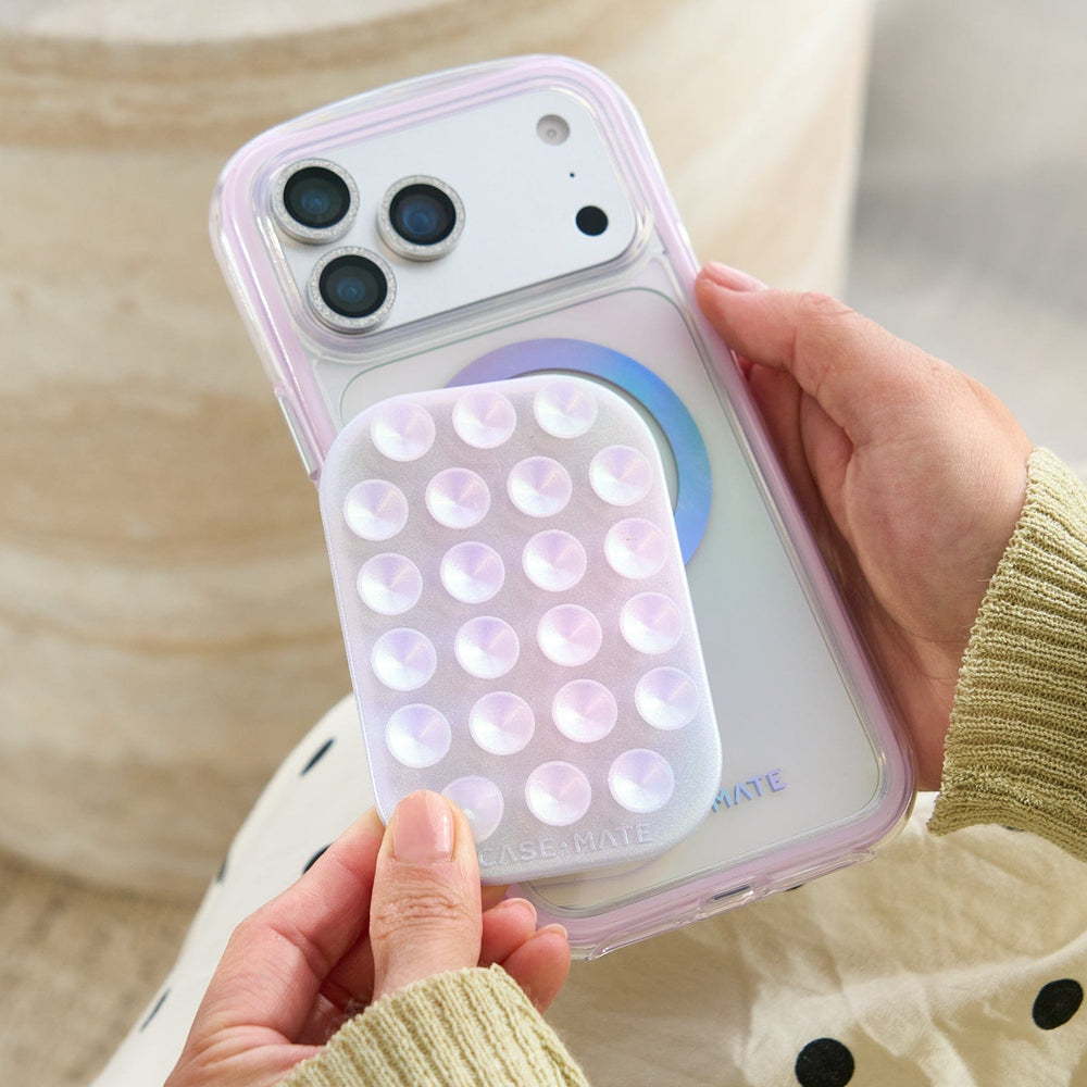 Phone case with bubble design held by a person #color_iridescent