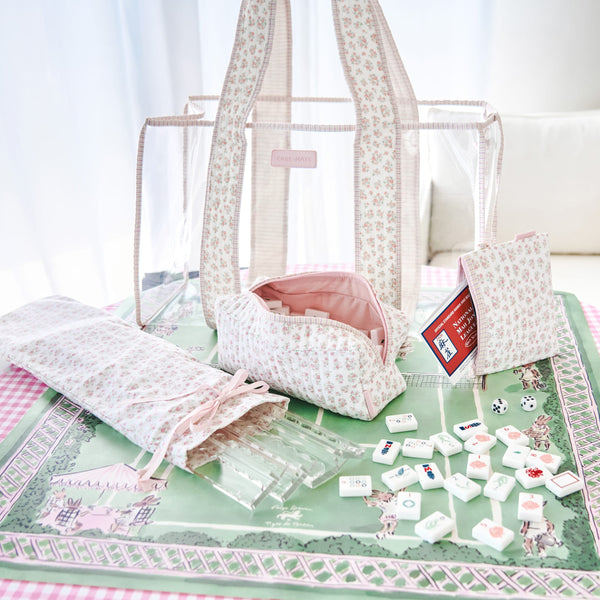 Set of white and pink bags with mohjong tiles and racks on a green mat #color_quilted ditsy floral