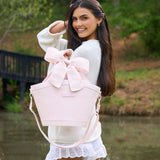 Woman holding a pink bow cooler tote (7L) outdoors