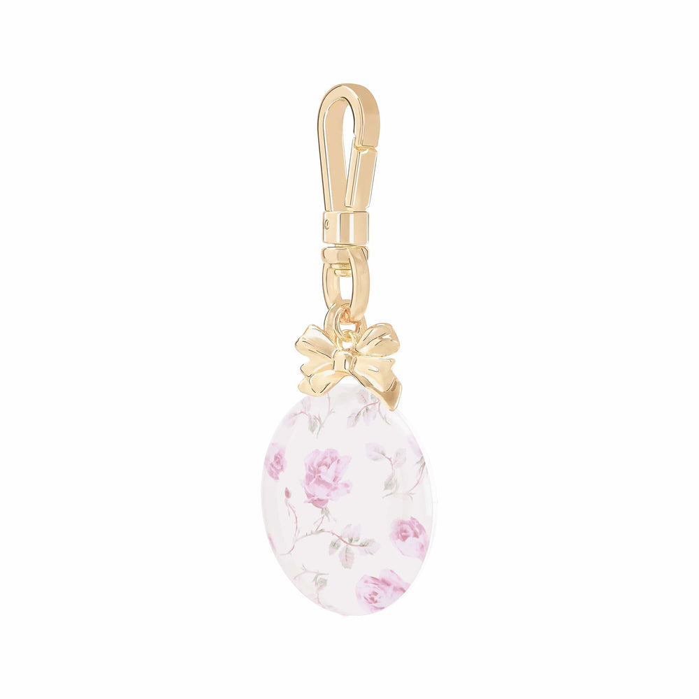 Gold charm with a floral design on a white background
#color_ribbon rosa flora