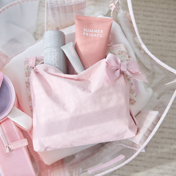 Pink skincare products including a bottle and tube with 'Summer Fridays' branding, placed on a white surface.
#color_ballet pink bow