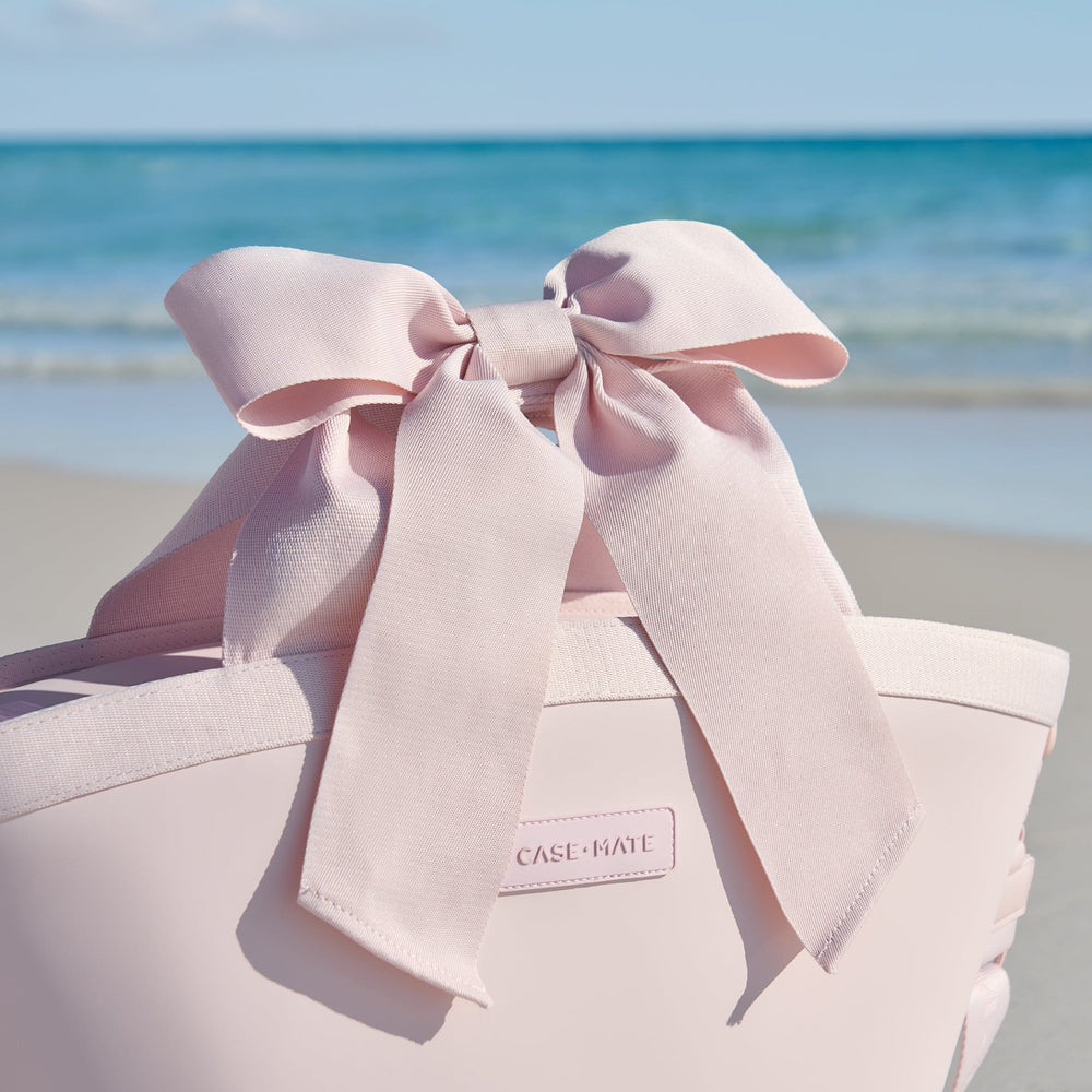 Pink cooler with a large bow on a beach #color_ballet pink bow