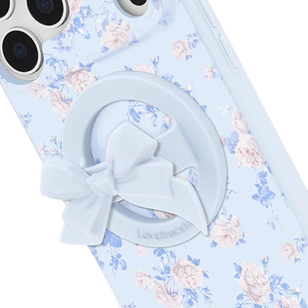 Light blue hair tie with a bow on a floral-patterned fabric background
#color_blue