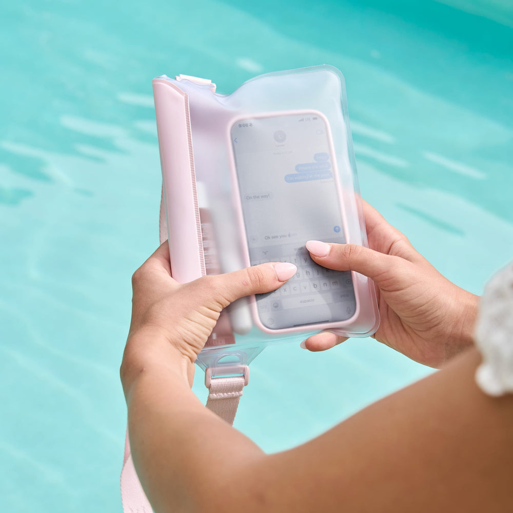 Person holding a phone with inside pink belt bag over water #color_ballet pink bow