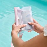 Person holding a phone with inside pink belt bag over water #color_ballet pink bow