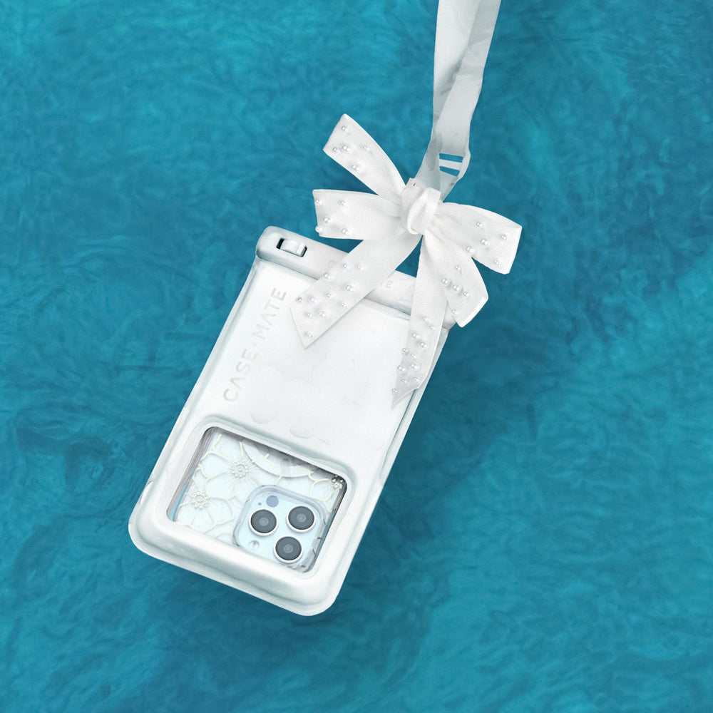 Clear phone case with a white bow on a blue textured background #color_ivory pearl bow