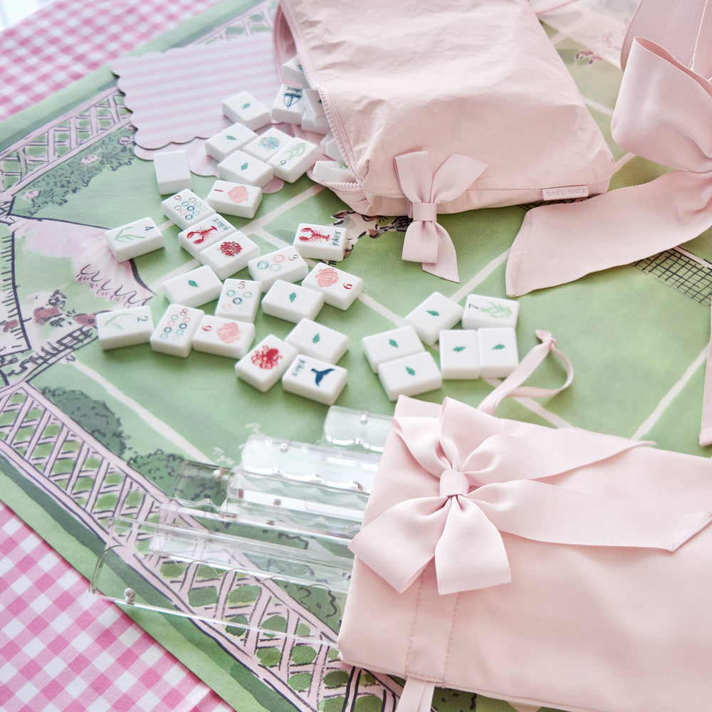 Mahjong tiles with designs on a pink and green mat #color_ballet pink bow