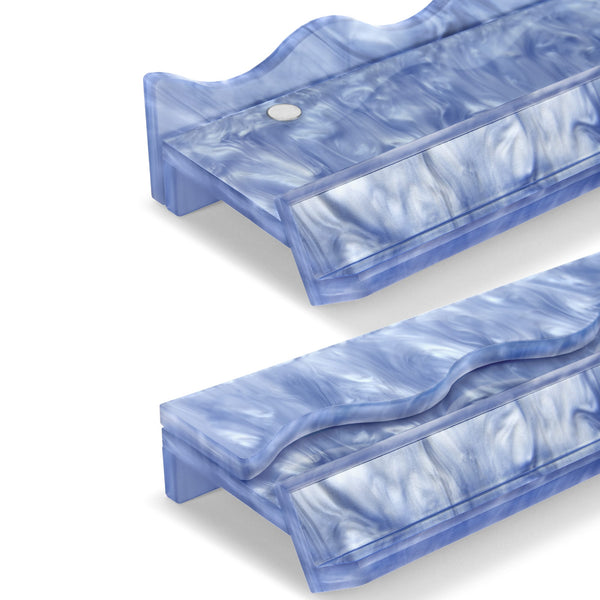 Two translucent blue marbled plastic stand pieces on a clean white 
#color_carolina blue pearl