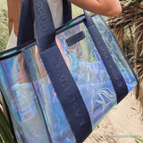 Close up shot showing the iridescent blue swirl on the jelly tote bag with navy blue straps #color_oxford navy iridescent