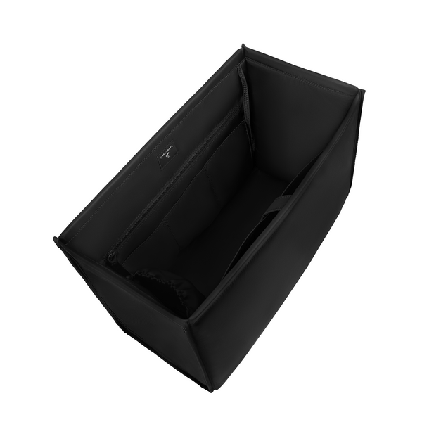Black fabric organizer insert with interior pockets, shown from an elevated angle on a plain white 
background.

#color_midnight black