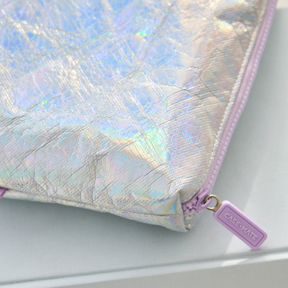 Iridescent case with a purple zipper on a white surface