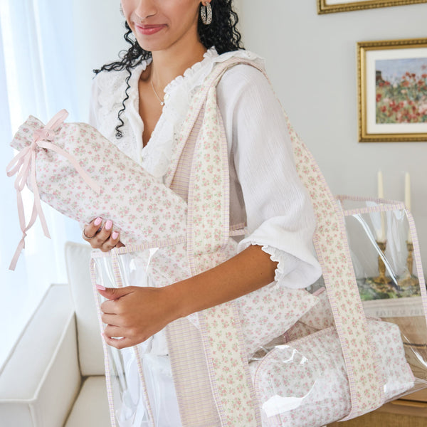 Woman holding a floral-patterned tote in a home setting #color_quilted ditsy floral