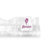A white ruffled baby garter belt with a central strap featuring an embroidered pink flower and the word 'flower' in pink 
#color_ivory pearl