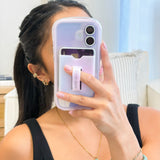 Person holding a phone with a clear case featuring a card holder.
#color_iridescent