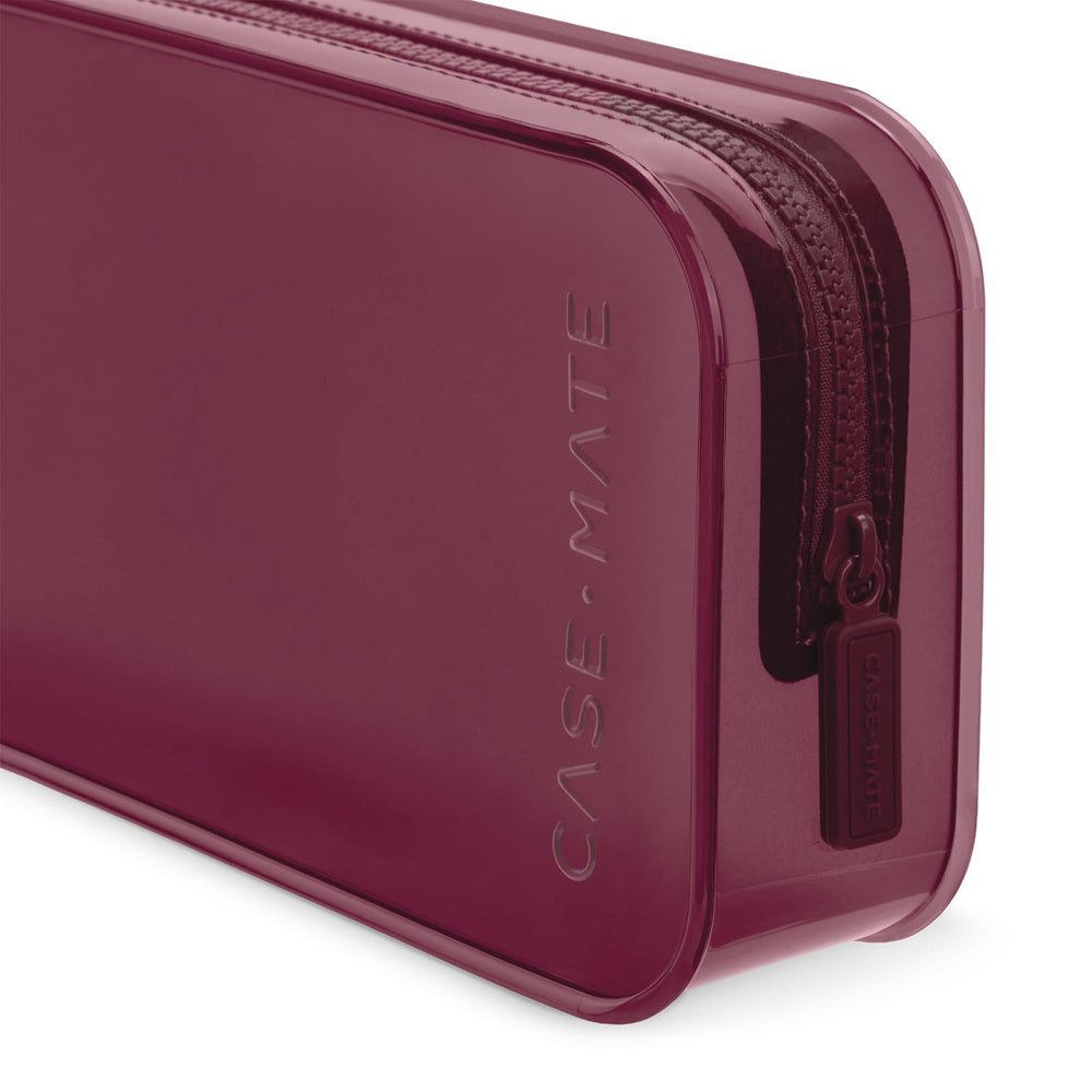 A close-up of a translucent burgundy zippered case with the brand name 'CASE-MATE' debossed vertically on the side and a matching zipper pull tab.

#color_mulberry