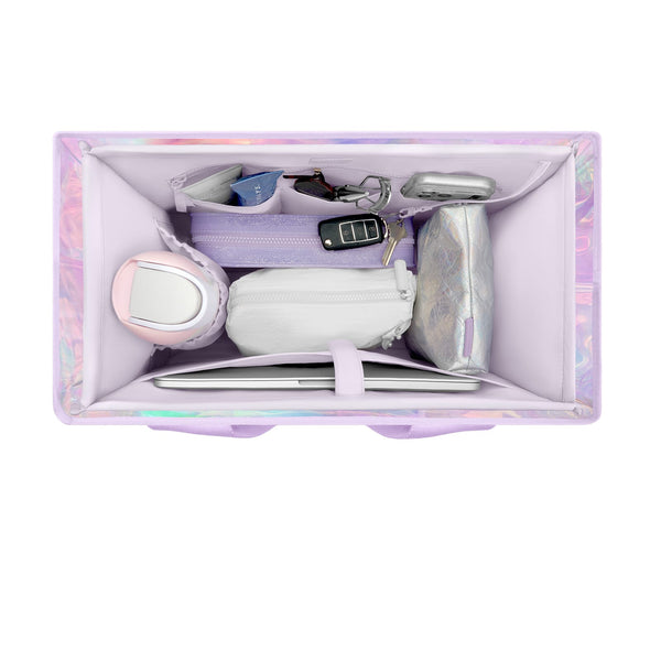 A lavender and holographic organizer box shown from above, filled with various small accessories including a pink and white hair dryer, a white pouch, a silver pouch, keys, and a tablet.
#color_lavender 