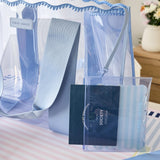 A light blue translucent plastic shoulder bag with a matching fabric strap, shown alongside a clear zippered pouch containing a Mahjong playing card

#color_carolina blue crochet wave