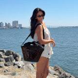 Woman standing by the coast with 7L mini cooler #color_tortoiseshell bow