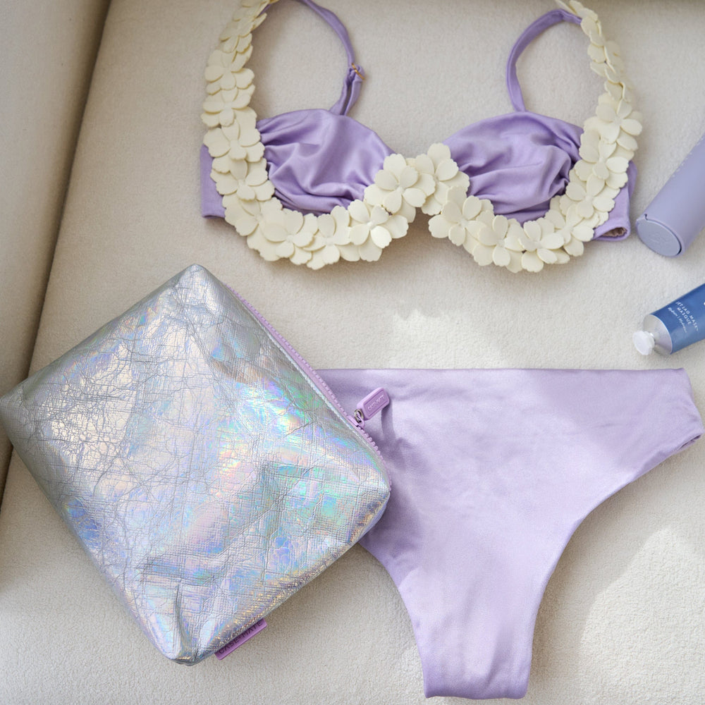 Lavender bikini set with matching pouch and accessories on a light background
#color_iridescent