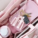 Pink keychain with keys on a pink surface
#color_ballet pink bow