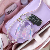 Purple cardholder with keychain and car key model on a pink surface
#color_iridescent