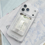 Clear phone case with glittery interior on a stack of books #color_twinkle