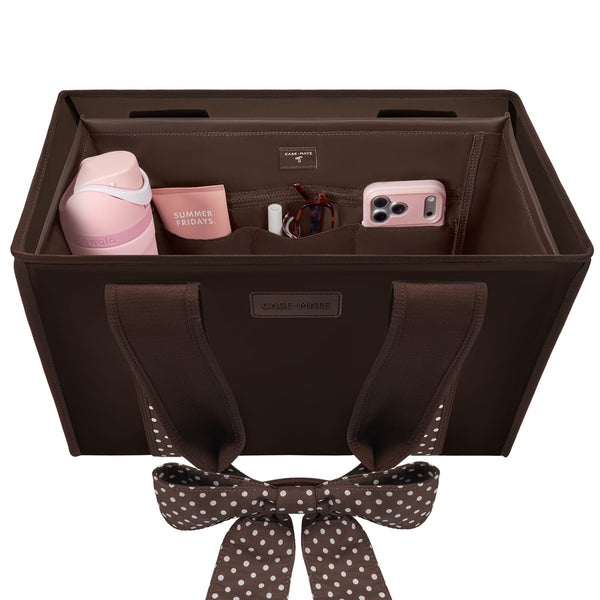 A brown fabric car organizer bag with a matching polka-dot bow, shown open to reveal interior pockets holding a pink bottle, mug, cord, and phone. The bag has a visible 'CASE-MATE' label and is photographed on a clean white background.

#color_espresso