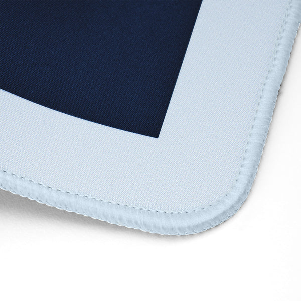 Close-up of a mouse pad corner showing a dark navy blue center surrounded by a wide light blue border with stitched edges on a white background.
#color_classic carolina blue
