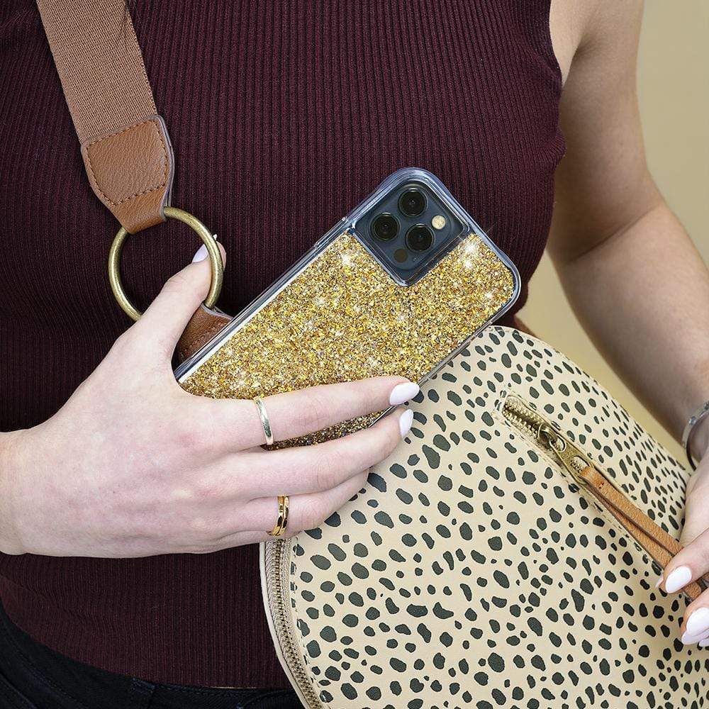 Hand holding gold sparkly case. color::Gold