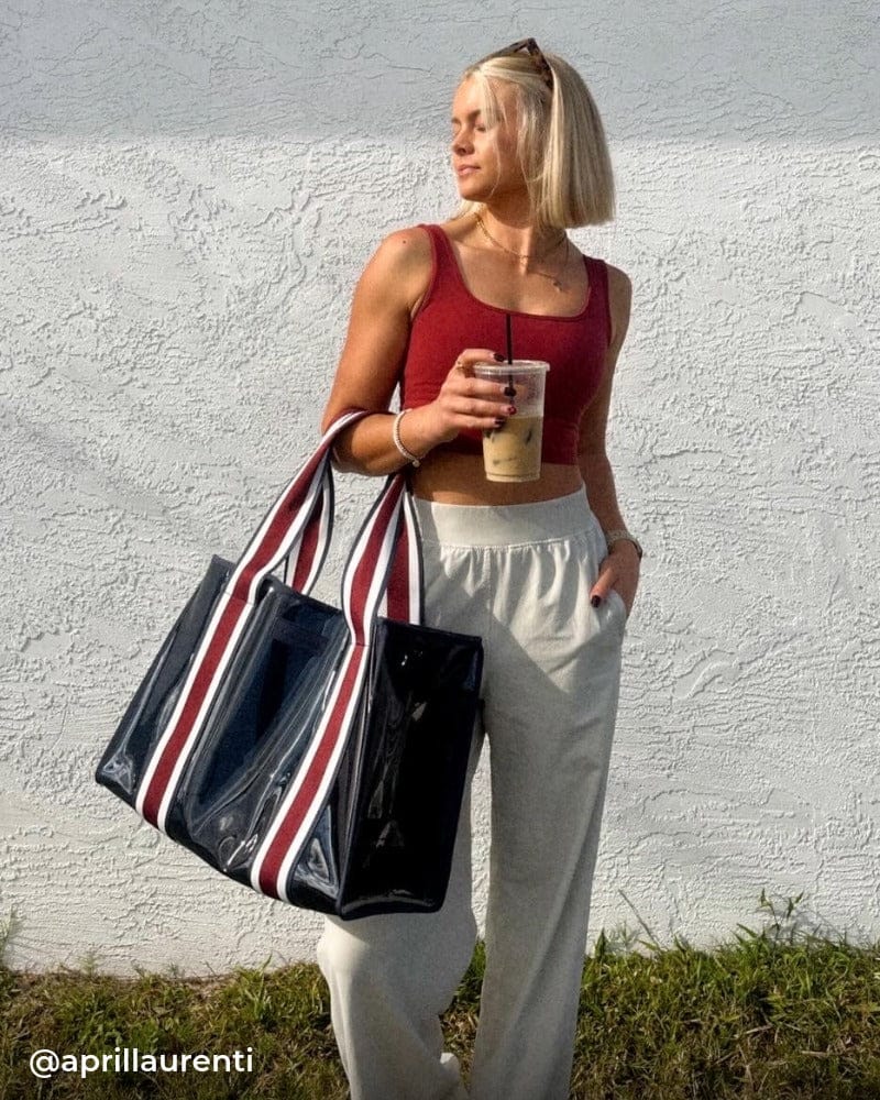 Girl in loungewear holding Navy Stripe Jelly Tote 