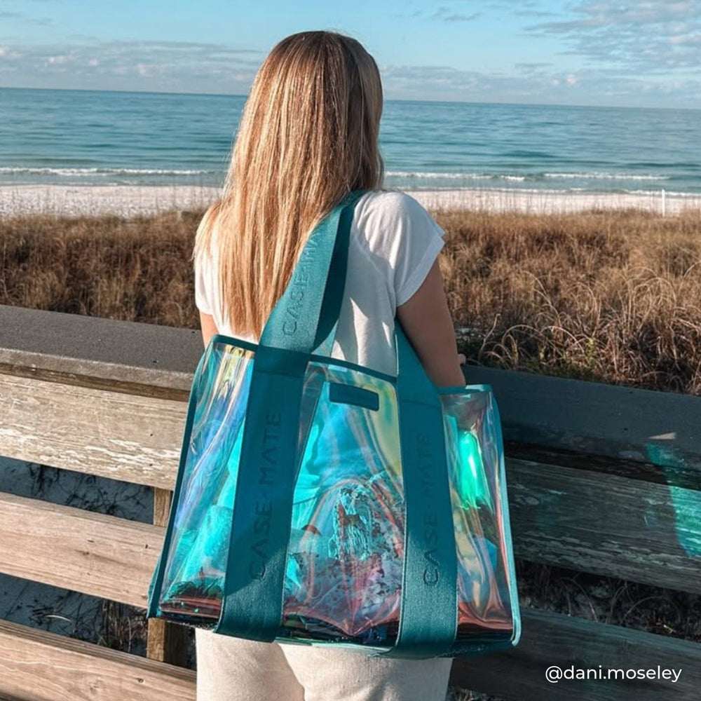 Person with a blue transparent tote bag Overlooking the by the beach.

#color_emerald blue soap bubble®