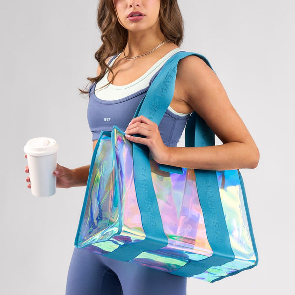 Woman holding a colorful transparent bag and a white cup on a gray background
#color_emerald blue iridescent