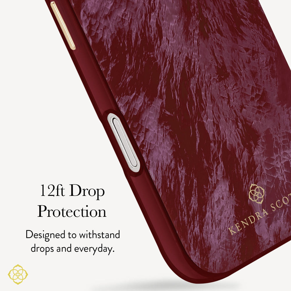A close-up of a phone case with a deep burgundy marbled texture and a metallic gold KENDRA SCOTT logo, featuring text that reads '12ft Drop Protection' on a clean off-white background.

#color_cherry lacquer pearl