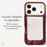 A Kendra Scott phone case with a deep burgundy marbled exterior, a gold-toned camera ring, and a white textured magnetic card holder pocket on the back. The left side of the image features text explaining 'Seamless MagSafe Compatibility' and 'Built-in magnets allow for wireless charging and accessorizing.
#color_cherry lacquer pearl