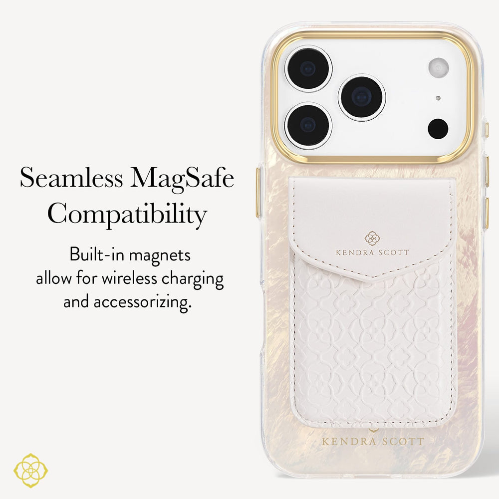 A Kendra Scott phone case with a white textured leather magnetic card pocket and gold-toned camera ring, shown on a light gray background with text reading 'Seamless MagSafe Compatibility' and 'Built-in magnets allow for wireless charging and accessorizing.'.
#color_cream pearl