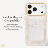A Kendra Scott phone case with a white textured leather magnetic card pocket and gold-toned camera ring, shown on a light gray background with text reading 'Seamless MagSafe Compatibility' and 'Built-in magnets allow for wireless charging and accessorizing.'.
#color_cream pearl