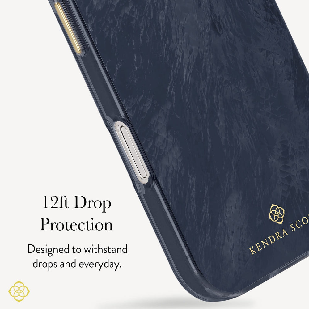 A close-up of a dark navy phone case with a subtle textured pattern, featuring gold branding for 'Kendra Scott' and a gold geometric logo. Text on the left reads '12ft Drop Protection' and 'Designed to withstand drops and everyday.

#color_navy pearl