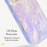 A close-up of a Kendra Scott phone case with a lavender and cream marbled pattern and a translucent purple bumper, shown with text highlighting 12ft drop protection. 
#color_blue pearl