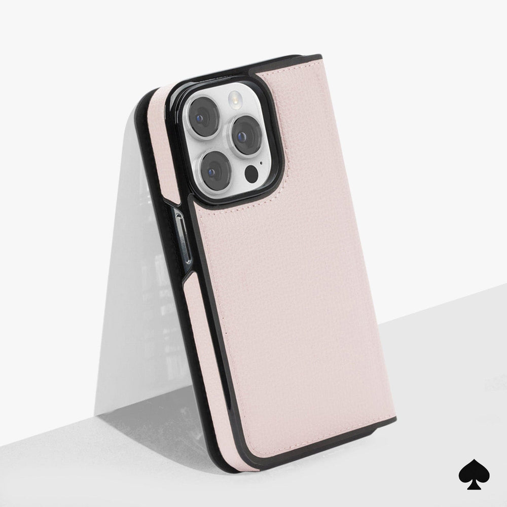 Pale vellum folio case with black trim and interior flap, shown open to display camera cutout and white interior lining.