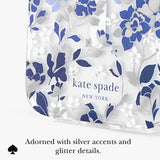 Kate Spade New York clear clutch bag with a blue and silver floral pattern, featuring the brand name printed on the front and a text overlay at the bottom describing silver accents.
#color_flowerbed blue